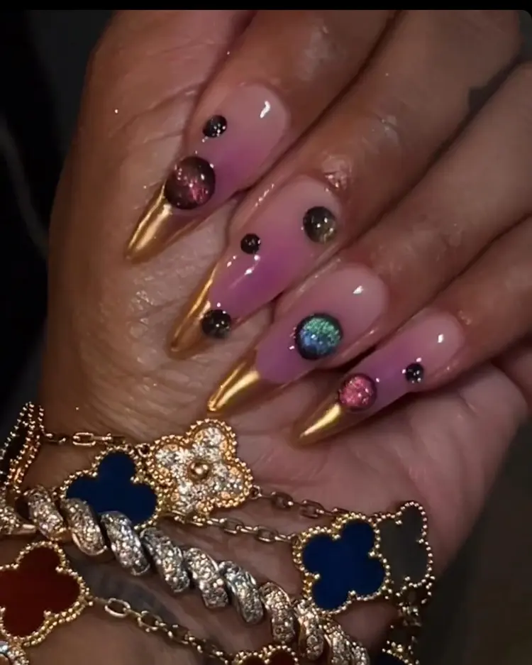 Gold stiletto nails with 3D gem embellishments